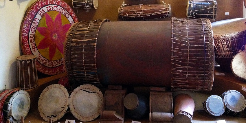 Percussion instruments like dhol and dafli are displayed at Janapada Loka, one of the places to visit near Bangalore for 1 day.