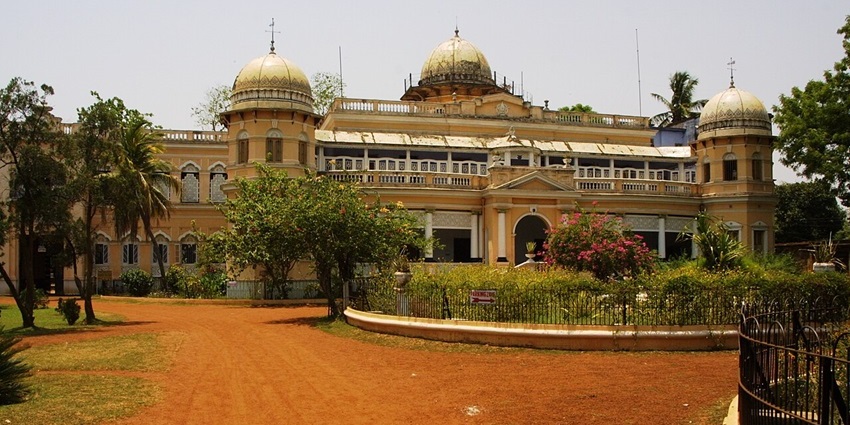 Jhargram Palace in Jhargram with a traditional architectural building, unique flowers and greenery.