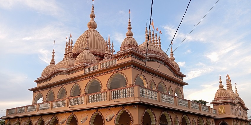 Shanti Ashram in Jorhat Assam with traditional design and flags among peaceful places to visit near Arunachal Pradesh.
