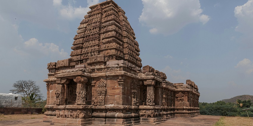 Jain temple with traditional architecture, multiple detailed stone-carved pillars, among spiritual places to visit near Gubbi.