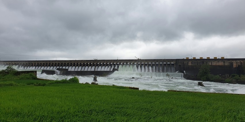 Krishna Raja Sagara Dam with calm water and surrounded by lush greenery.