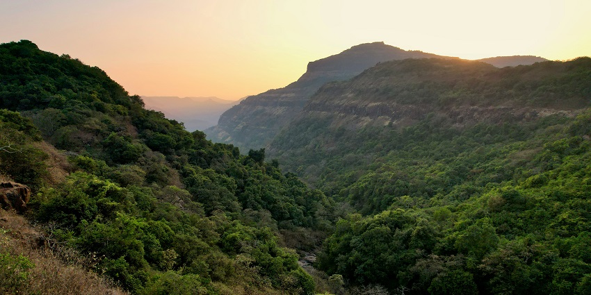 Rolling green hills and cloudy skies over a peaceful valley in Kamshet.