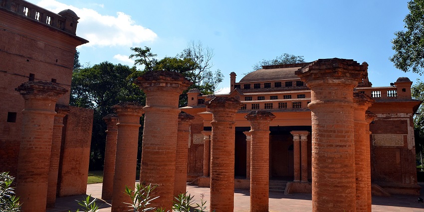 Historic red-brick structure with columns, one of the places to visit near Imphal.
