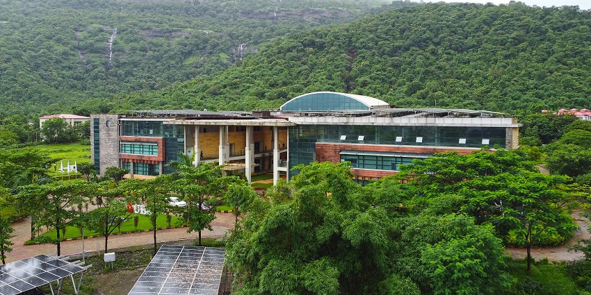 Sleek glass-fronted building in lush hills, one of the best places to visit near Mumbai for 3 days.