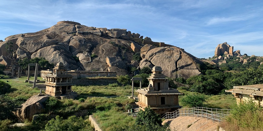 View of Karnala Fort amidst lush green hills and clear blue sky.