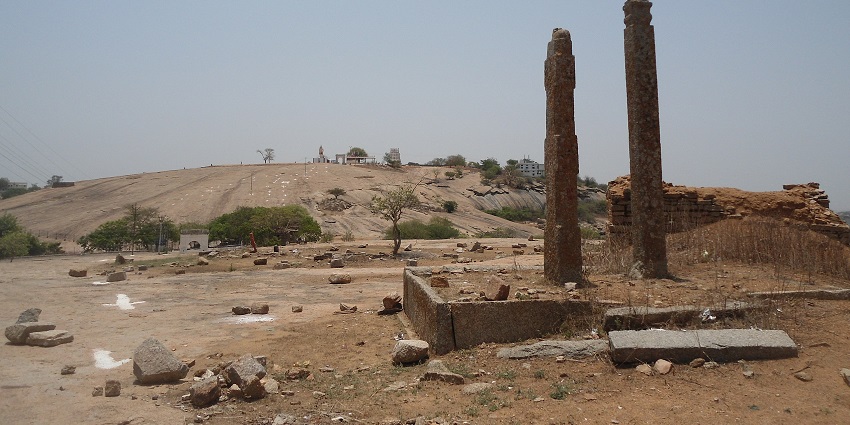 Remnants of stone columns on rocky terrain, one of the scenic places to visit near Kadthal.
