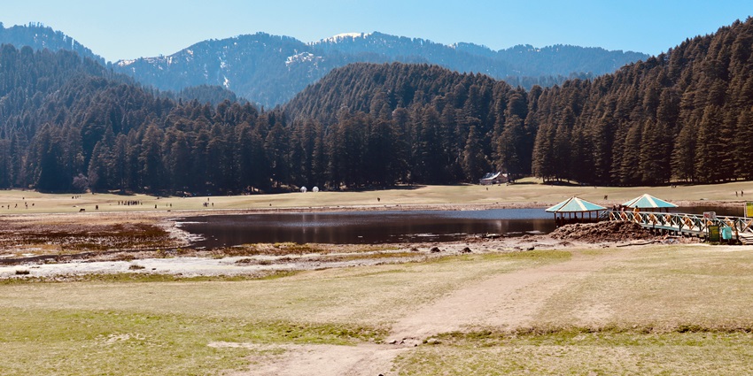 Khajjiar lake with surrounding mountains is among the most scenic places to visit near Dalhousie in December.