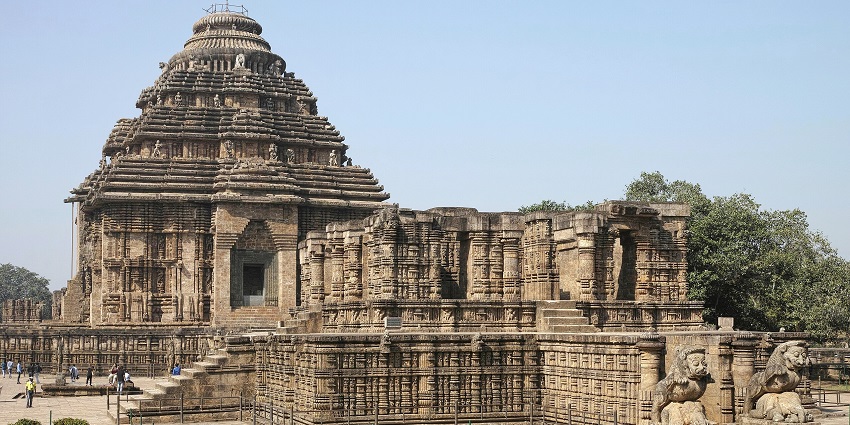 Konark Sun Temple in Odisha, with traditional Hindu architecture, and people visiting the temple.
