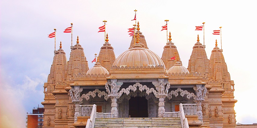 Exterior view of the Kusuma Devi Temple with traditional architecture and stairs.
