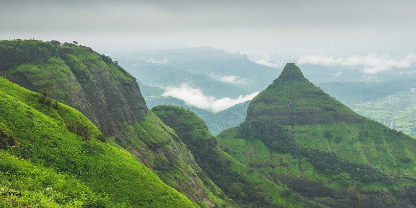 Lion’s Point in Lonavala with unique rock formations of the mountains and green grass, one of the top places to visit near Bhushi Dam.