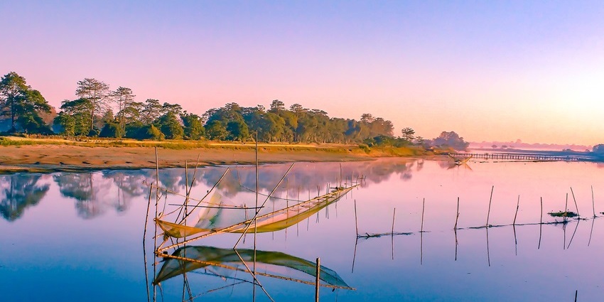 Majuli Island in Assam with calm water, lush greenery, and peaceful natural surroundings.
