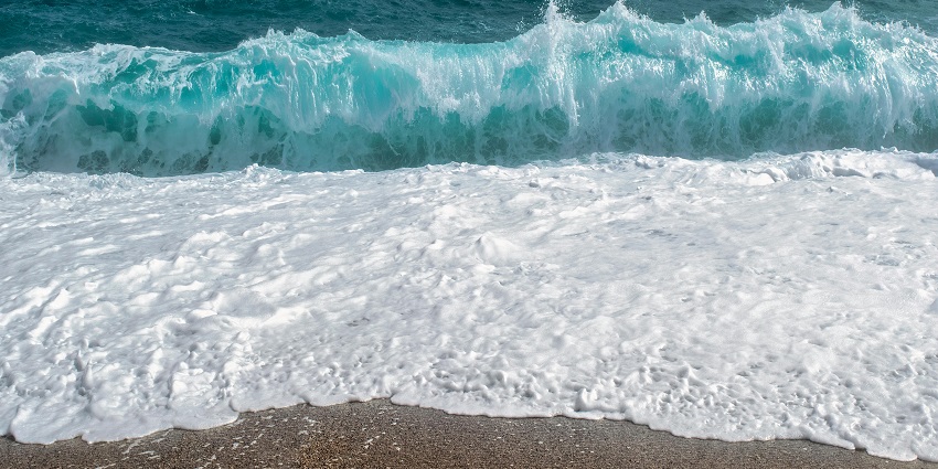 View of Marina Beach in Chennai with sandy shoreline and waves crashing.