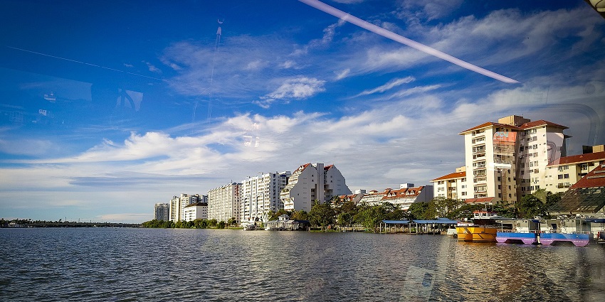 Marine Drive waterfront with Water Metro boats and the city skyline reflected in the sea