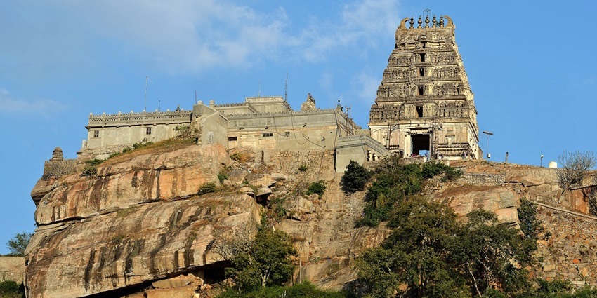 Melukote temple on hill surrounded by green trees places to visit near Adichunchanagiri.