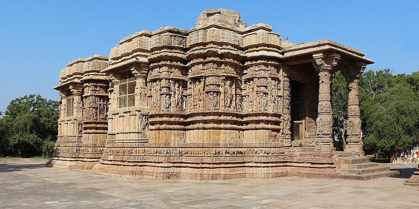 Ancient sand temple with beautifully carved golden pillars under the bright blue sky