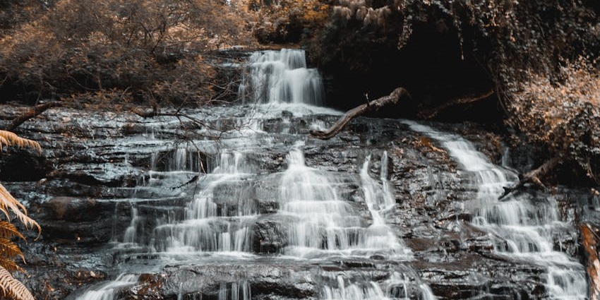 Water cascades over rocks at Monkey Falls, one of the most beautiful places to visit near Kodiveri.