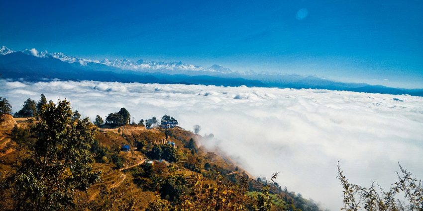 Nagarkot scenic Himalayan landscape with lush green hills and distant mountains.