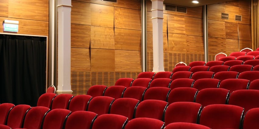 Interior view of Nandan West Bengal Film Centre theatre with rows of seats and lighting.
