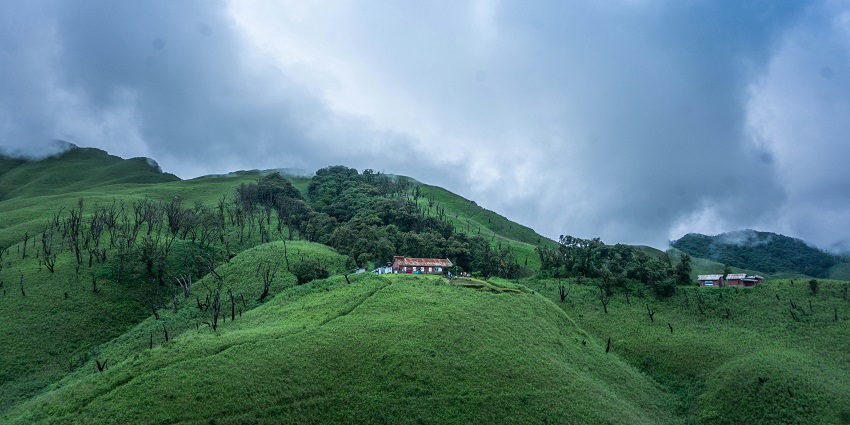 Scenic view of Nongmaiching Hill, one of the scenic places to visit near Imphal, with lush greenery.
