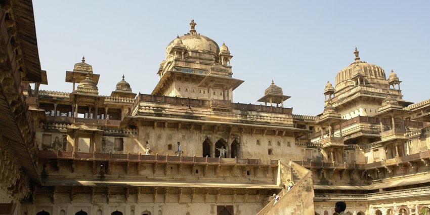 Jahangir Mahal in Orchha with multiple unique gumbads, and people visiting the palace.