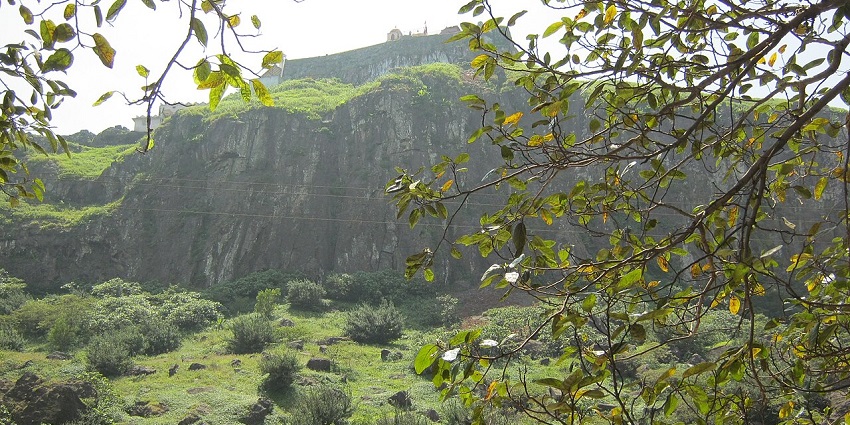 Pavagadh hill in Gujarat with green grass, bushes, trees, one of the best places to visit in monsoon near Vadodra.
