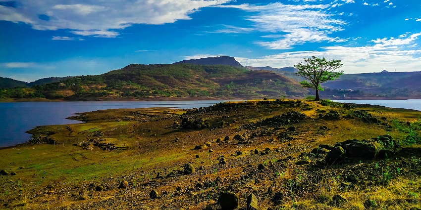 Tranquil waters of Pawna Lake with hills and mountain peaks, one of the top places to visit near Pune for 2 days.