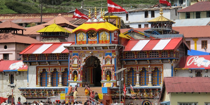 Sacred Badrinath Temple with colorful facade set against a dramatic mountain backdrop.
