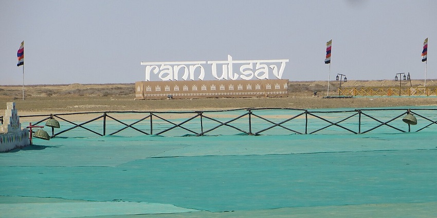 Open desert landscape decorated with vibrant colors during the Rann Utsav festival.
