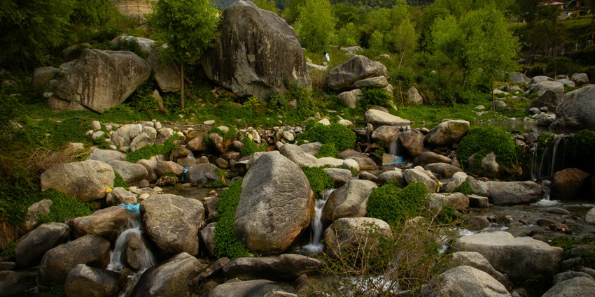 Stone pathways and artistic rock sculptures surrounded by trees at the Rock Garden.