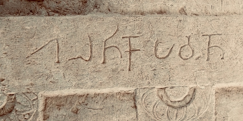 An ancient language is carved on the walls of the Sannati archaeological site, one of the best places to visit near Gulbarga.