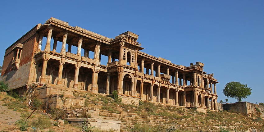Historic structures and stone archways at the tranquil Sarkhej Roza complex in Ahmedabad.