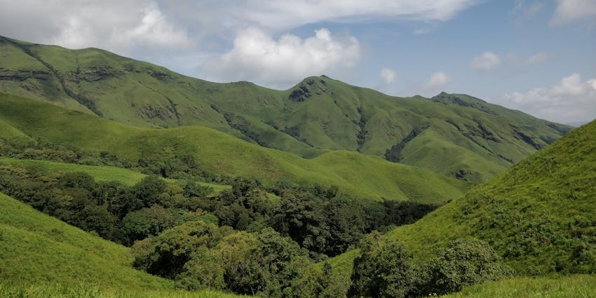 A wide view of the giant Savandurga Hills with lush greenery, one of the iconic places to visit near Bangalore for 1 day.