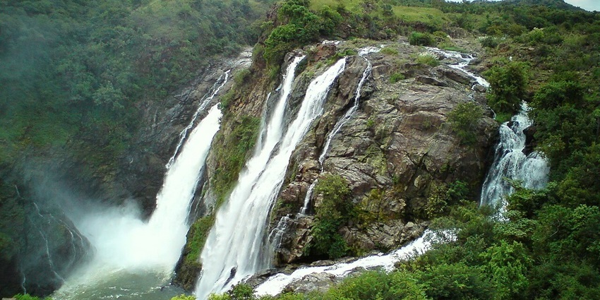 Shivanasamudra falls in Kerala, with multiple waterfalls flowing on the rocky surface and greenery.