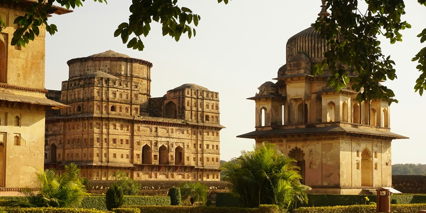 An ashram complex with serene surroundings and traditional architecture in rural India.