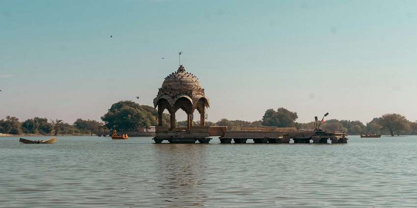Fort reflected in calm water with cloudy skies during the quiet monsoon season in Jaisalmer.

