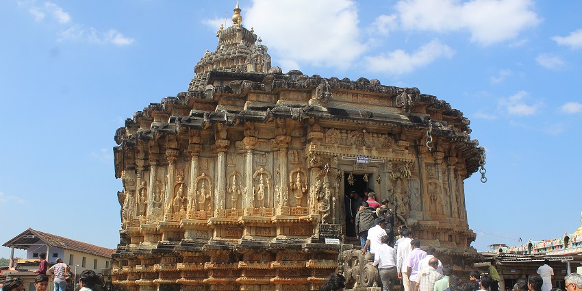 Serene temple with intricately carved stone pillars and sloped roof, one of the peaceful places to visit near Kavaledurga.