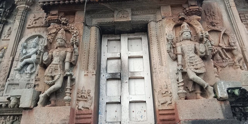 Intricately carved temple doorway with detailed stone sculptures and ornate patterns