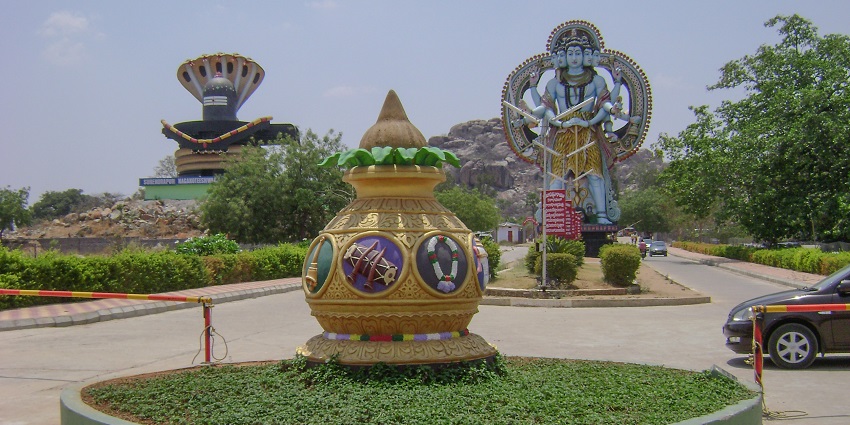 Large colorful Linga statues near a decorated roundabout, one of the vibrant places to visit near Kadthal.

