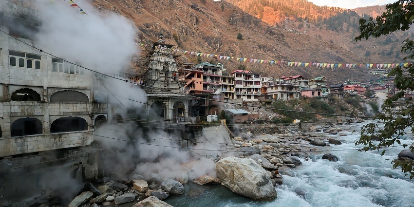 A natural hot spring with rocky surroundings and steam rising from warm water pools.