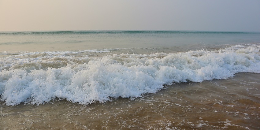 Golden Beach waves crashing on sandy shore—discover what is Puri famous for.