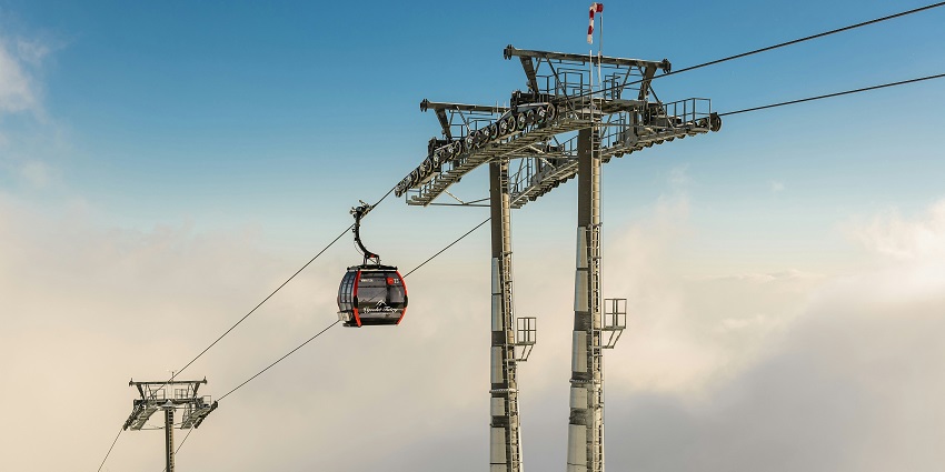 Cable car ride over snowy hills in Auli showcasing what is Auli famous for.
