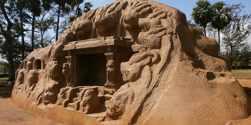 Ancient Tiger Caves rock-cut monument with ornate lion carvings and a clear blue sky