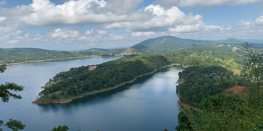 Scenic view of Umiam Lake near Shillong surrounded by green hills and calm waters.