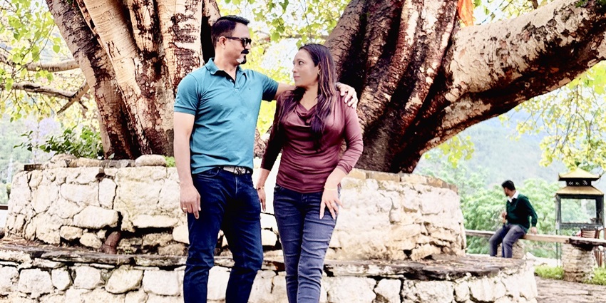 A view of a loving couple enjoying their fun-filled trip to Bhutan with amazing backdrop.