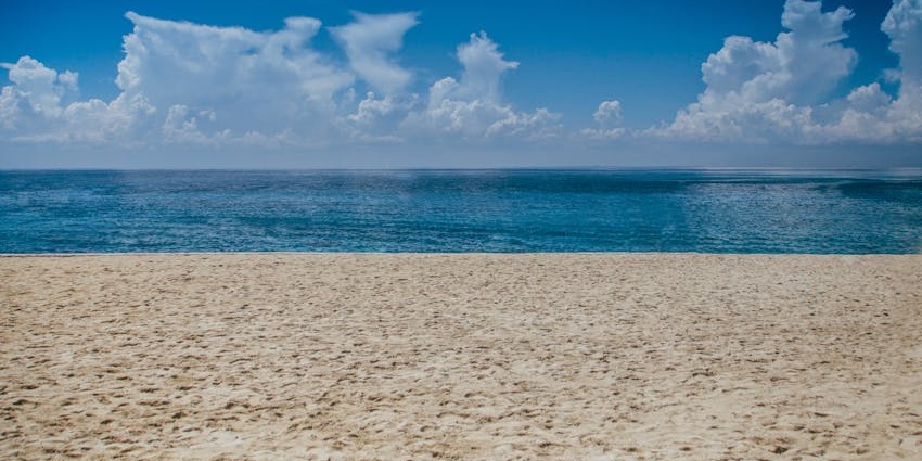 Velas Beach wide sandy shore and calm waters, one of the best places to visit near Harihareshwar Beach.
