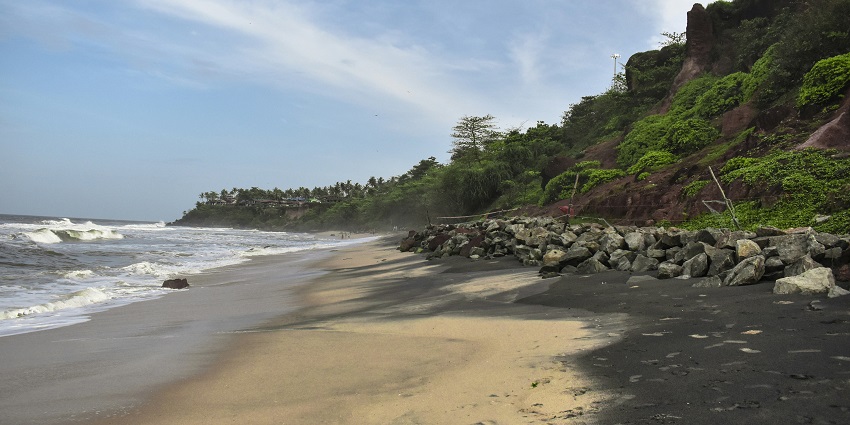 Veli Tourist Village beach with calm waters, sandy shore, and surrounding greenery.
