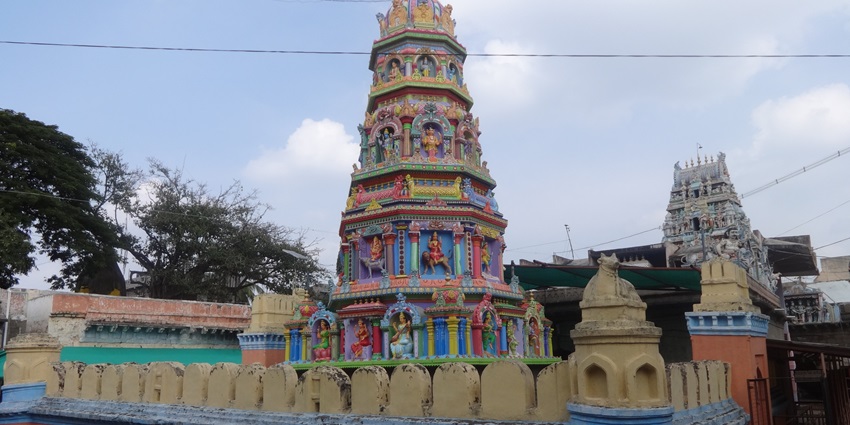 Colourful gopuram of Lord Veerabhadra Temple in Yadur, India, with intricate carvings.