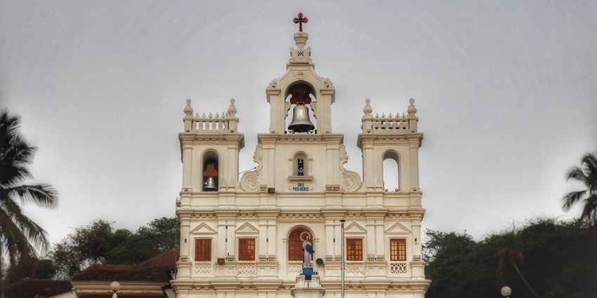 Exterior view of the Church of Our Lady of Brotas with stone walls and tiled roof.