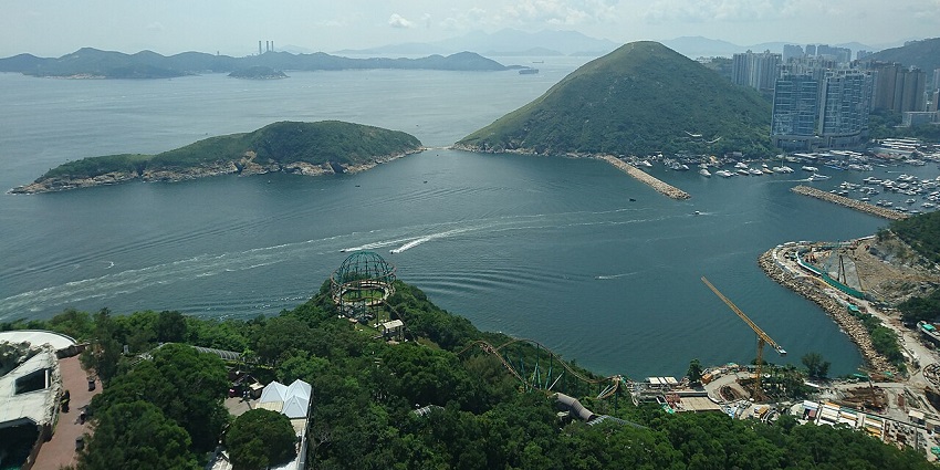 Ap Lei Chau and nearby islands with boats along the shore surrounded by water in islands in Hong Kong.