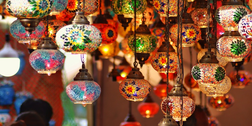 A night market is set up on a street with many food stalls and people walking around.
